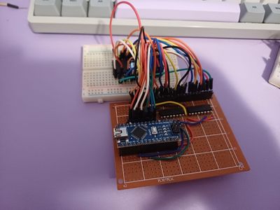 Picture of a PCB with an Arduino NANO to two 74HC595 with wires going to a flash rom chip mounted on a breadboard