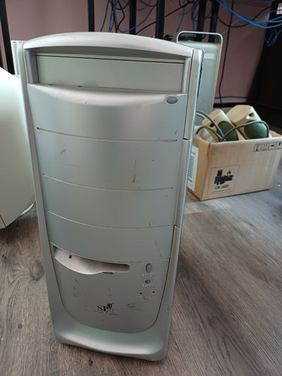 A gray desktop PC case with scratch marks. On the lower side there's a logo that says SP Super Power